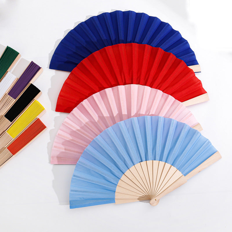 Ladies folding hand fan made of airy material with intricate folds Stornfield
