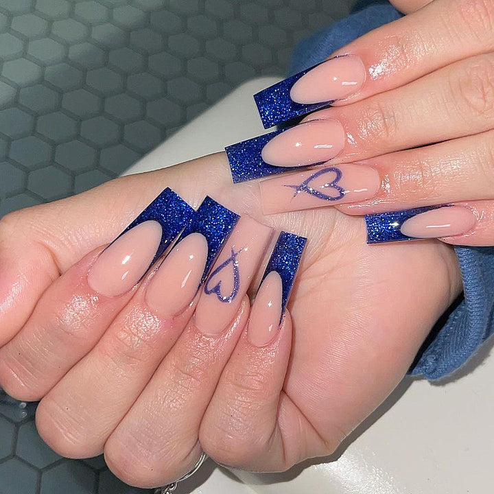 Artificial nails with glitter accents and unique heart design Stornfield