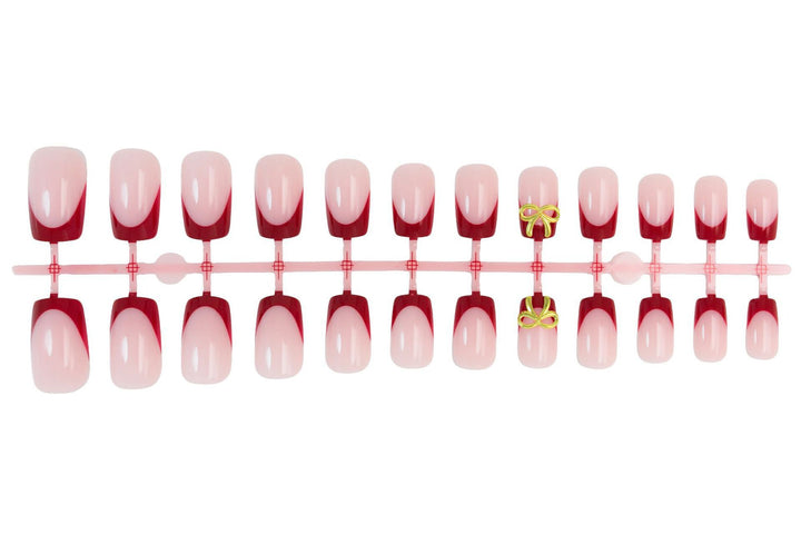 Artificial nail set with elegant red tips and refined bow decorations Stornfield
