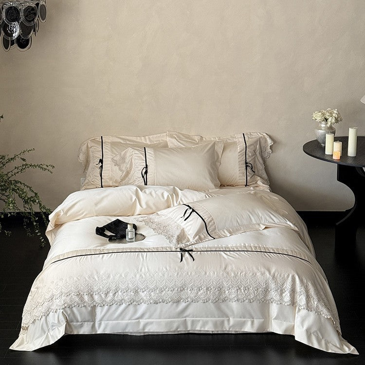 Fine cotton satin bedding set with lace ruffle, contrasting decorative ribbons and hotel closure