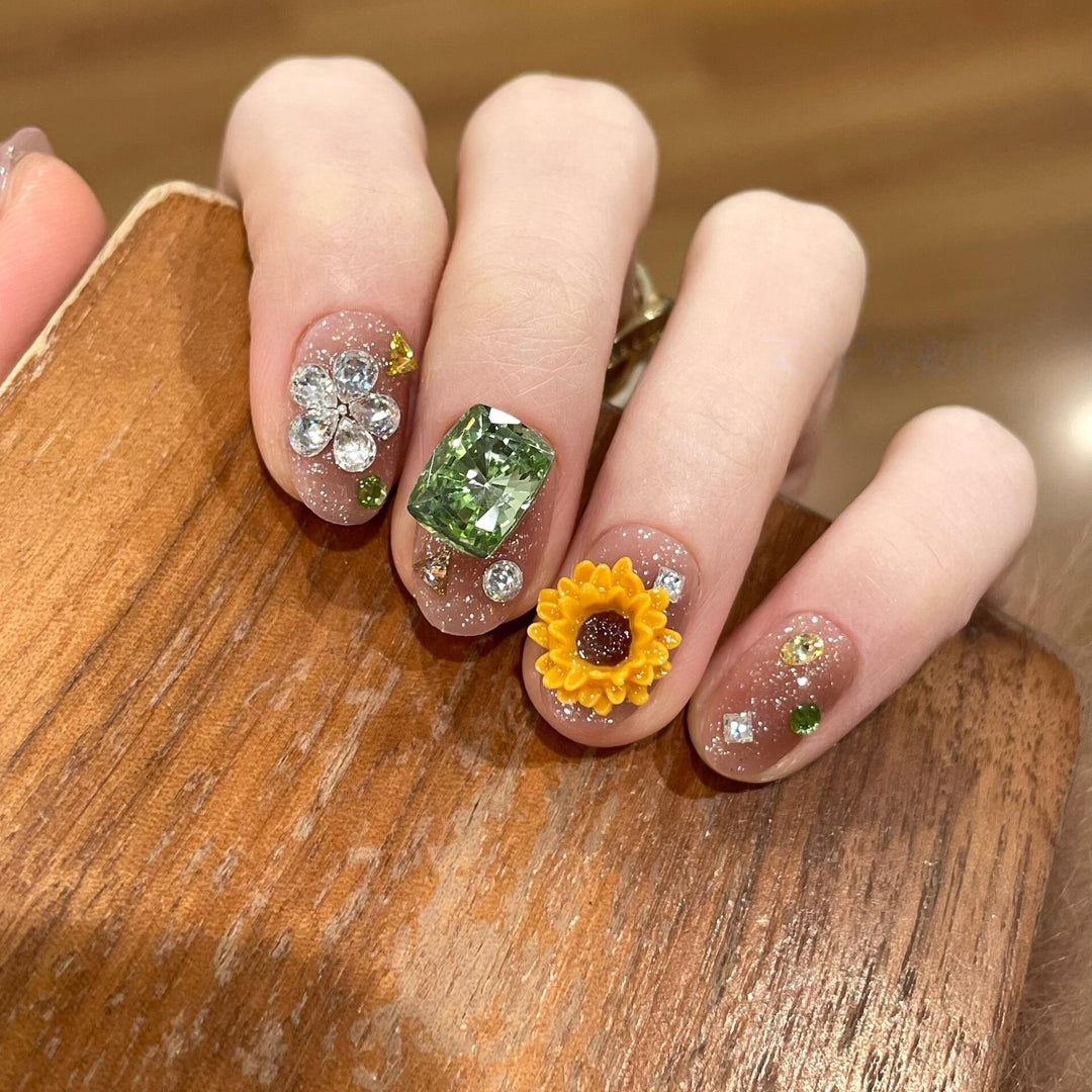 Artificial nails with sparkling appliqués and floral designs Stornfield