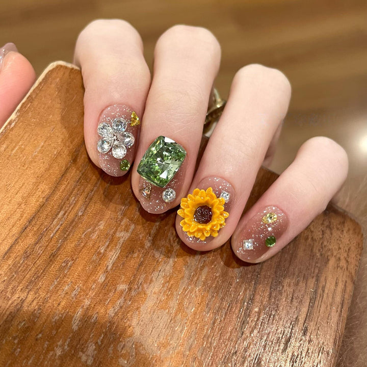 Artificial nails with sparkling appliqués and floral designs Stornfield