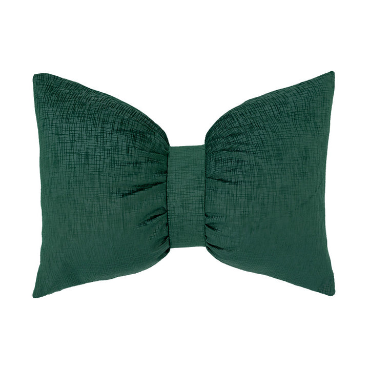 Bow-shaped decorative cushion with central band detail and structured fabric look