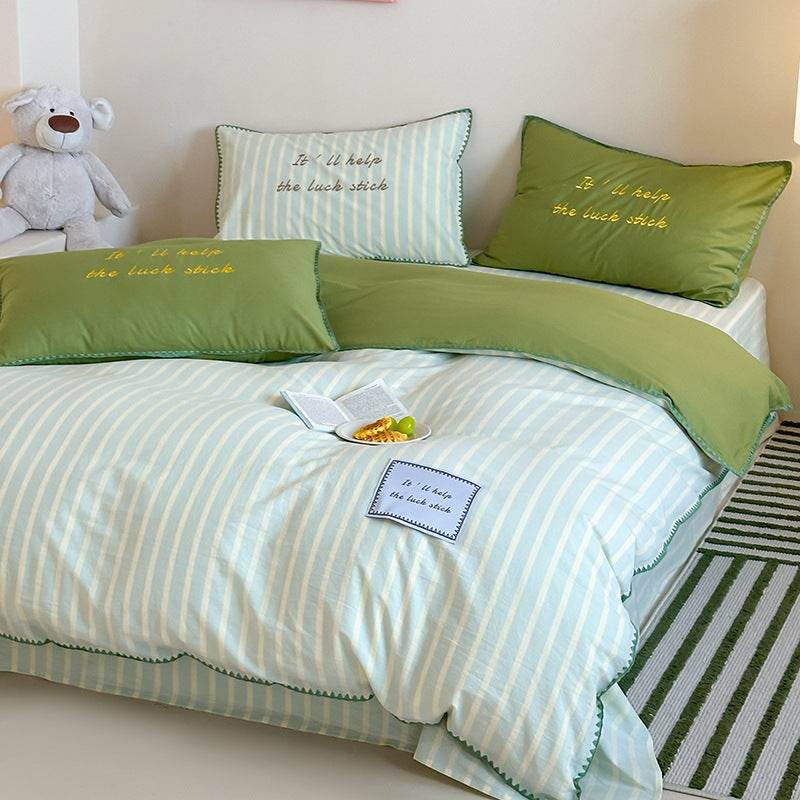Striped cotton bedding set with subtle slogan appliqués and decorative piping