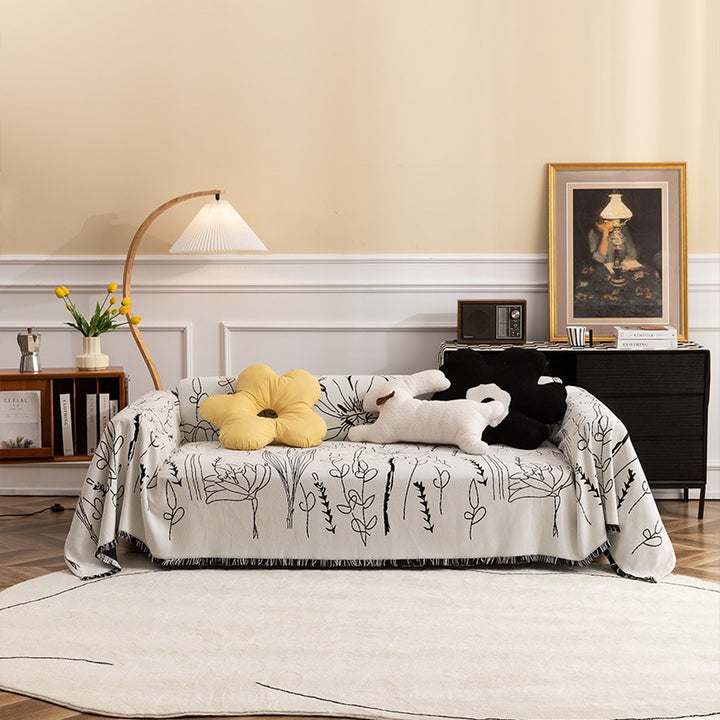 Light woven sofa cover with botanical line print and fringe hem