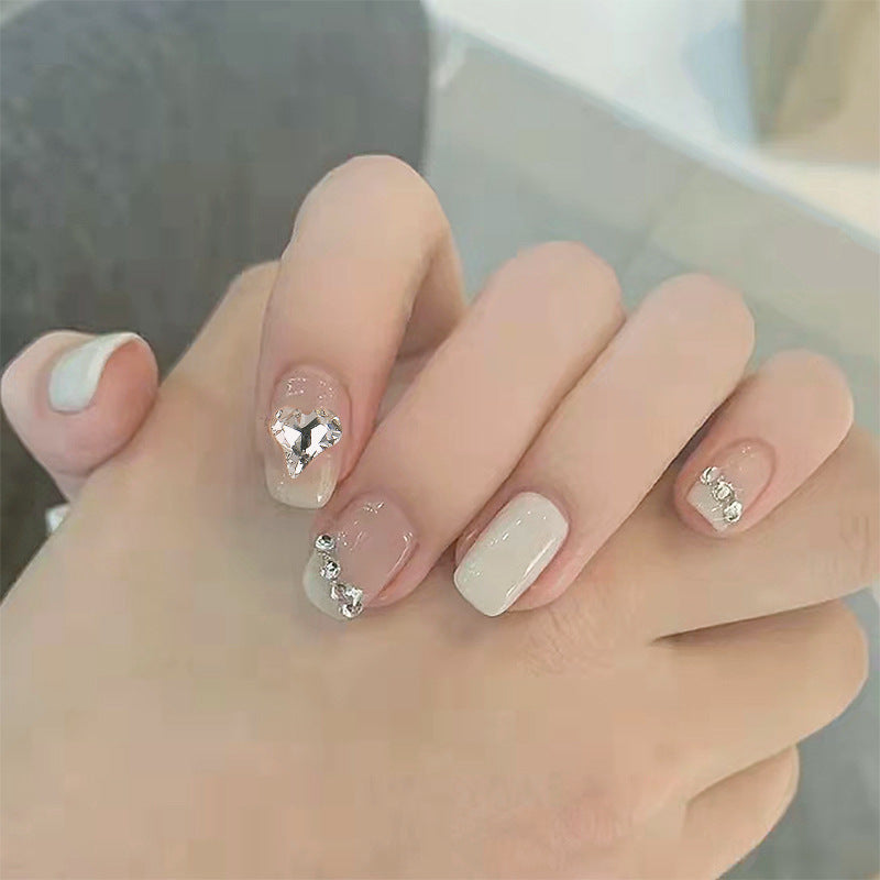 Glamorous artificial nails with heart and rhinestone decorations Stornfield