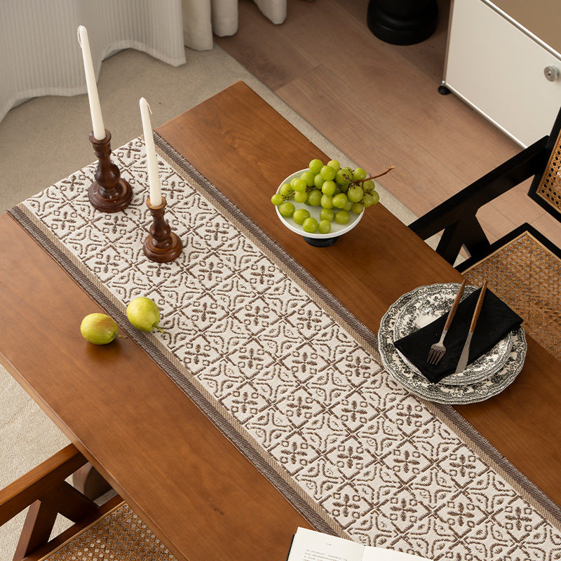 Decorative table runner with woven ornament jacquard and finely hemmed edges Stornfield