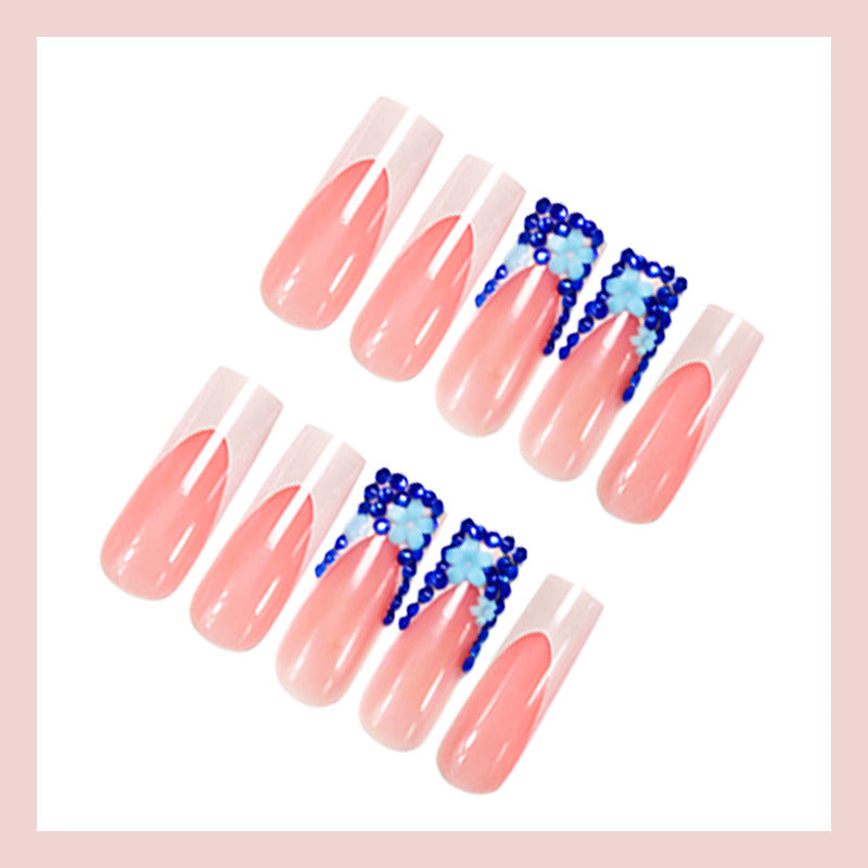 Artificial nail design with trendy blue accents and glitter coating Stornfield