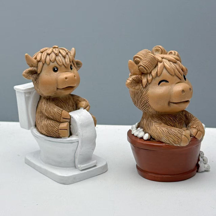 Funny decorative figure of a Highland cow on toilet Stornfield