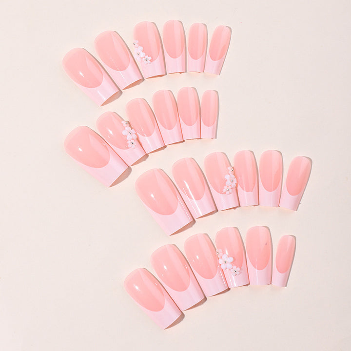 Artificial nail set with elegant French tips and hand-drawn flower motifs Stornfield