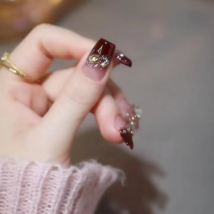 Artificials nails with glitter embellishments and elegant accents Stornfield