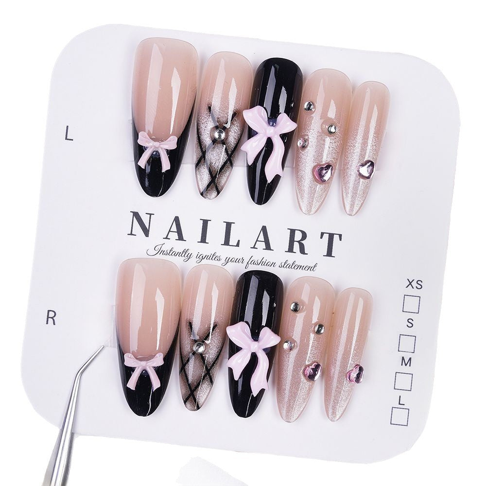 Artificial nails with playful bow design and glitter effects Stornfield