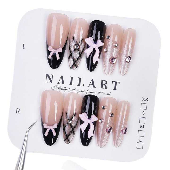 Artificial nails with playful bow design and glitter effects Stornfield