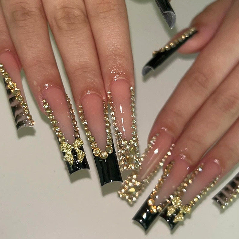 Acrylic nail set with glamorous 3D bows and radiant rhinestone decorations Stornfield