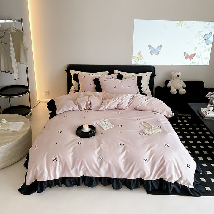 Reversible cotton satin bedding set with fine bow embroidery and ruffled edge