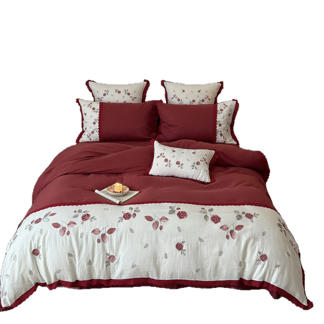 Bedding set with embroidered rose motif, ruffle and reversible feature
