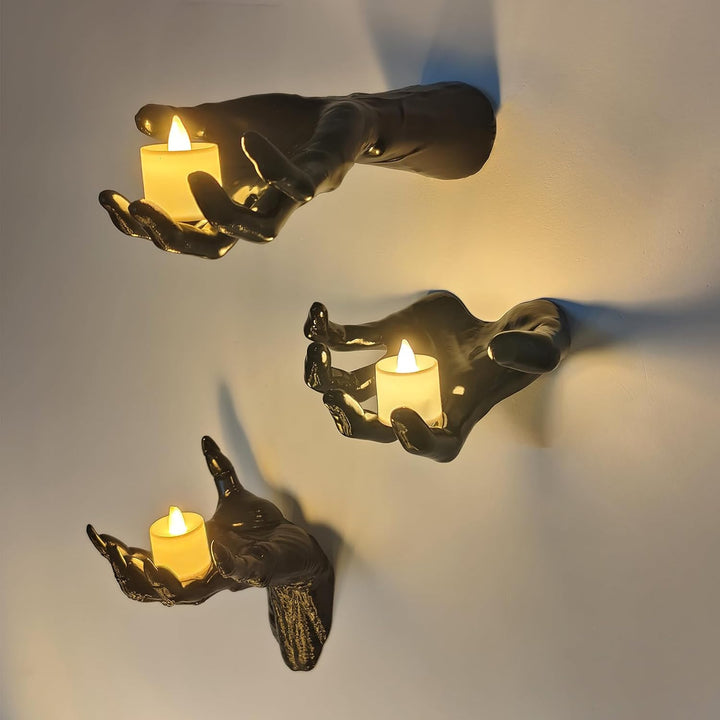 Wall candle holder in realistically shaped hand made of resin