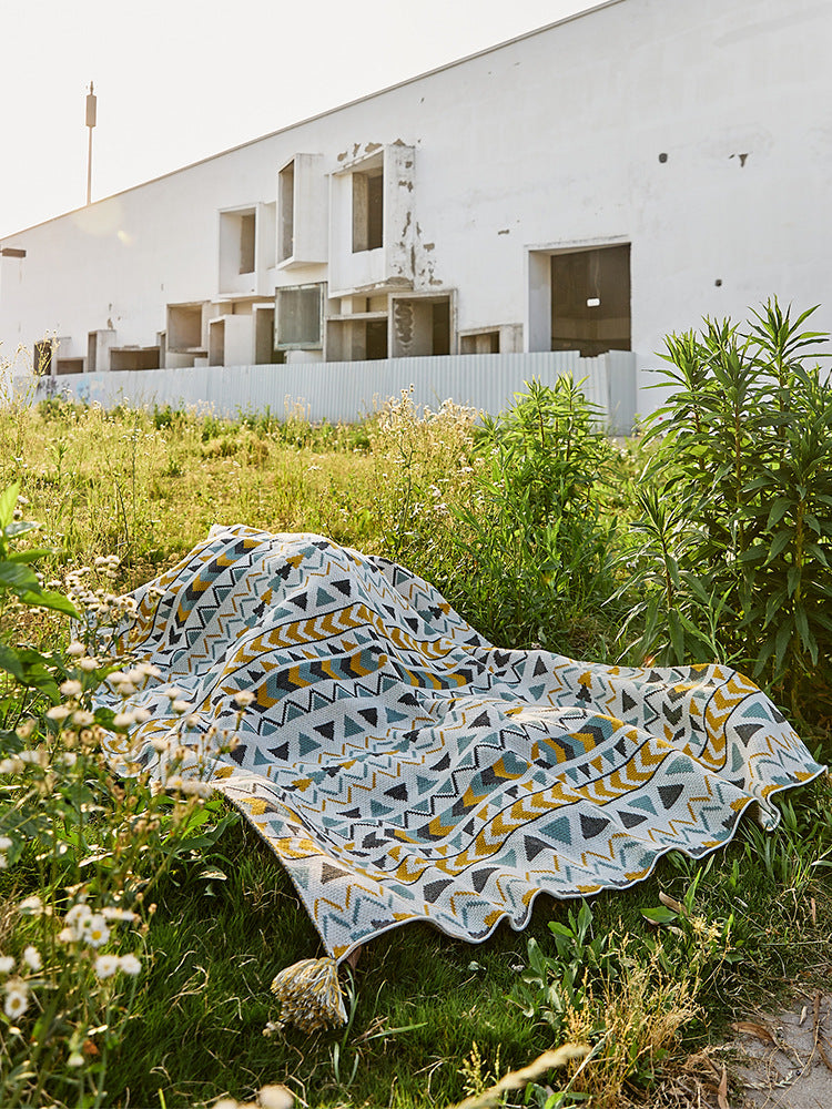 Patterned throw blanket in ethnic knit design with tassels