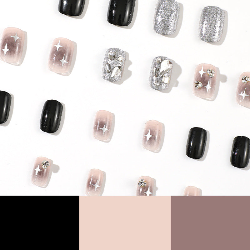 Elegant Nail Art with Glitter and Star Motifs Stornfield