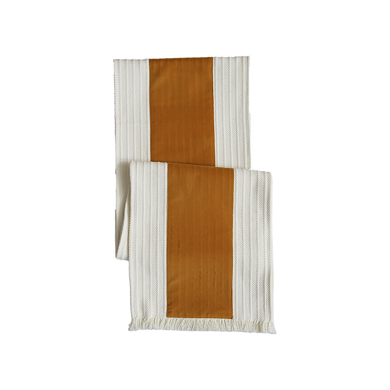 Woven table runner with contrasting center stripe, textured waffle look and decorative fringes