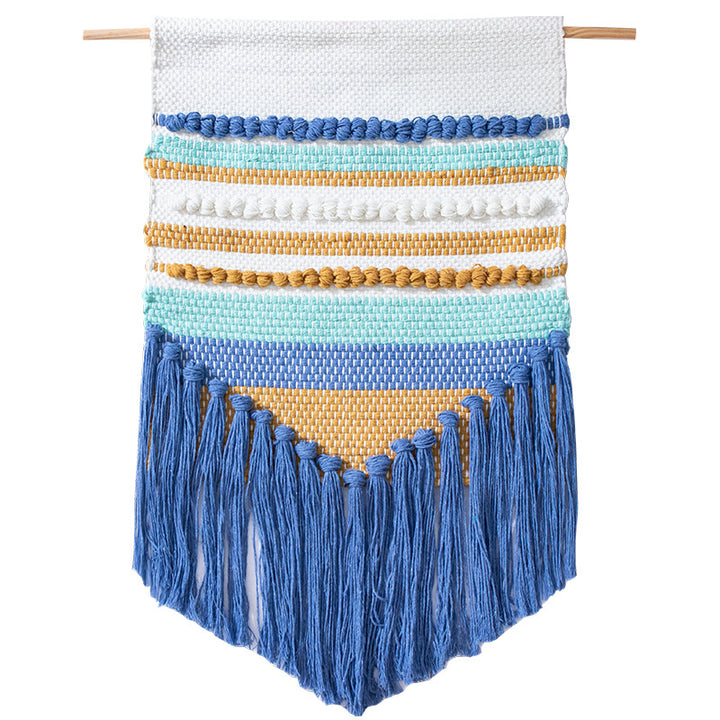 Handwoven wall hanging in boho style with tassels and geometric structure