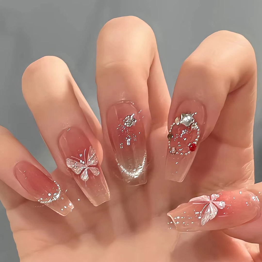 Artificial nail extensions with floral design and sparkling accents Stornfield