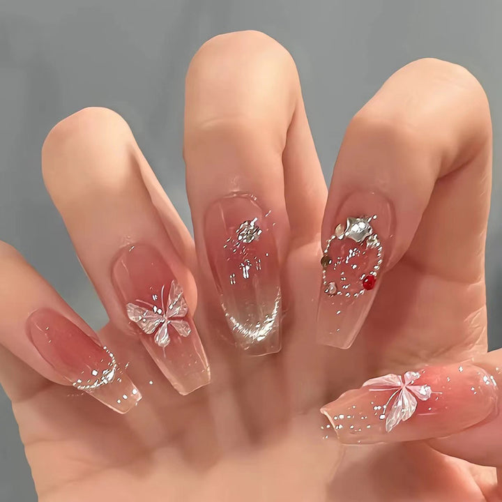 Artificial nail extensions with floral design and sparkling accents Stornfield