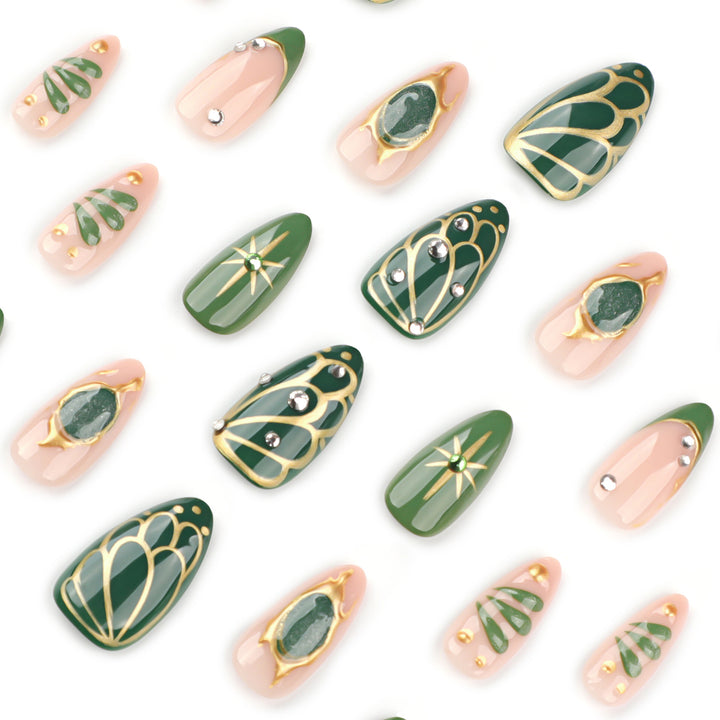 Artistic nail extensions with elegant gold and green shimmer Stornfield