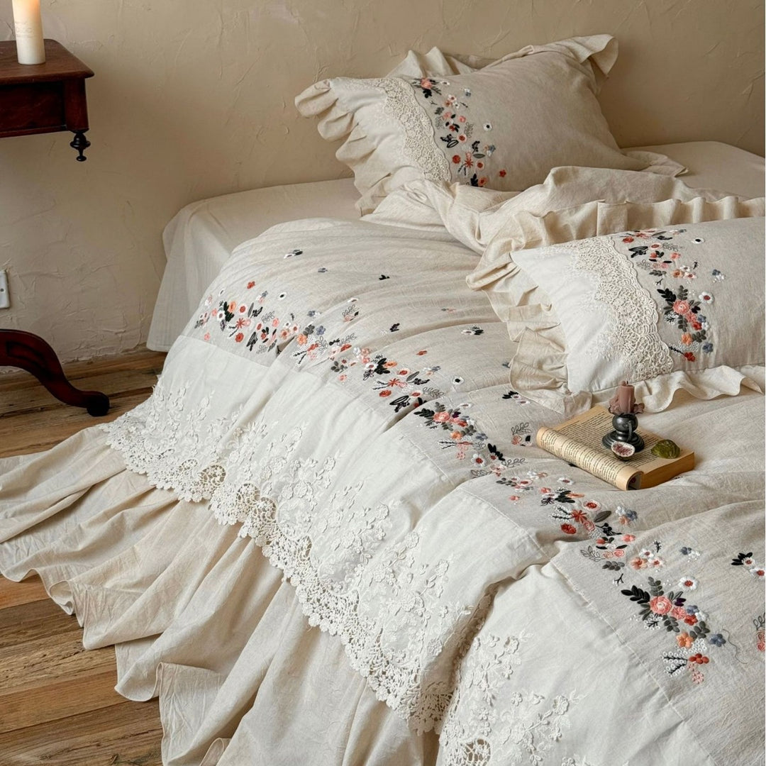 Romantic bedding set in country house style with embroidered border, frill and lace appliqué