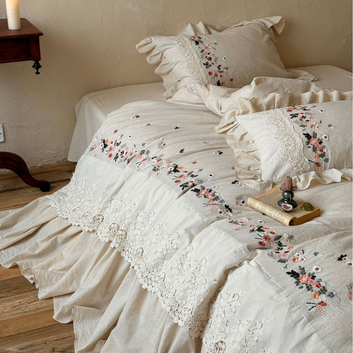 Romantic bedding set in country house style with embroidered border, frill and lace appliqué