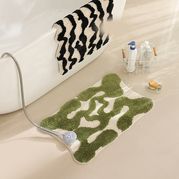Hand-tufted bathroom bath mat with non-slip backing and textured square relief Stornfield
