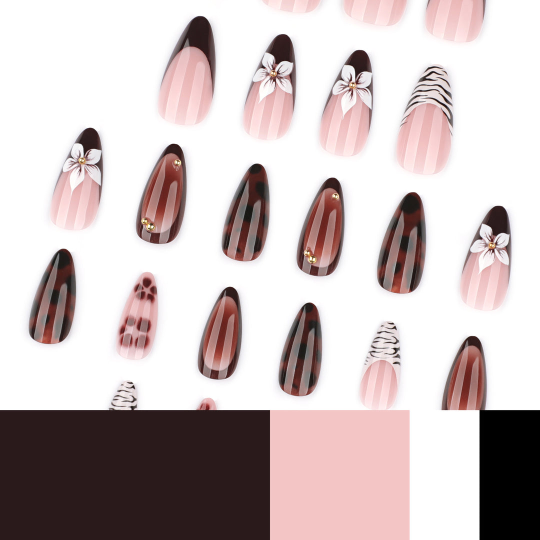 Artistic stiletto nails with elegant floral designs and glitter accents Stornfield