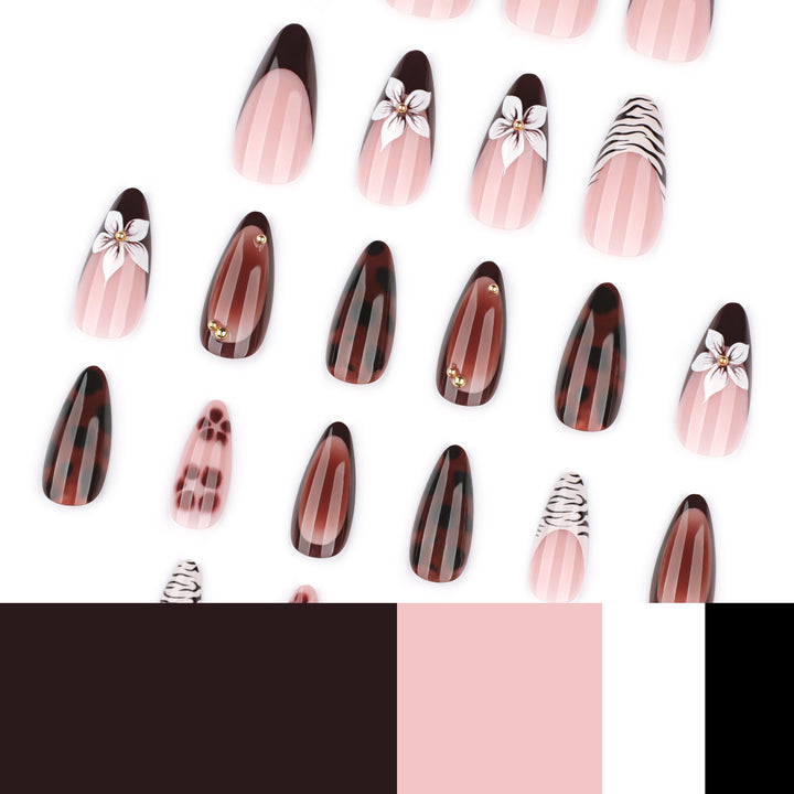 Artistic stiletto nails with elegant floral designs and glitter accents Stornfield