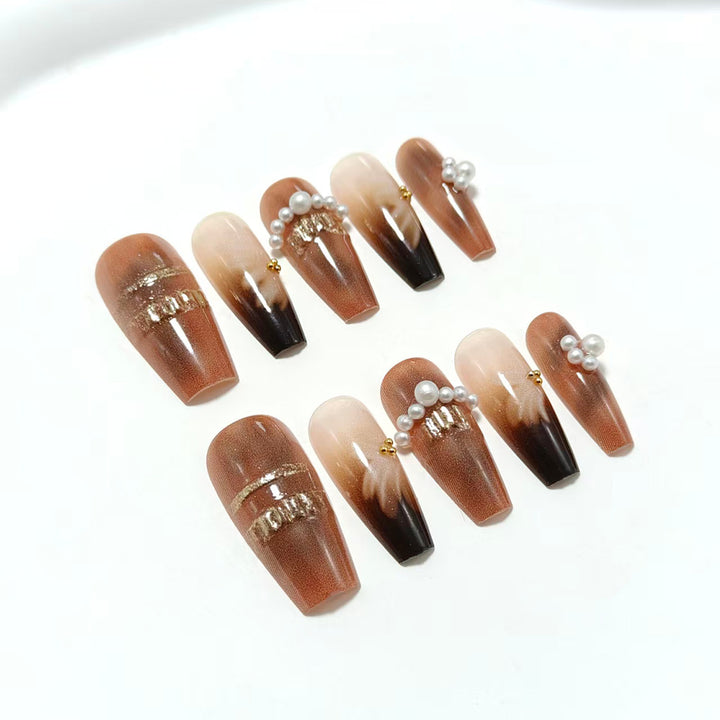 Artificial nails with glamorous gold and pearl embellished accents Stornfield