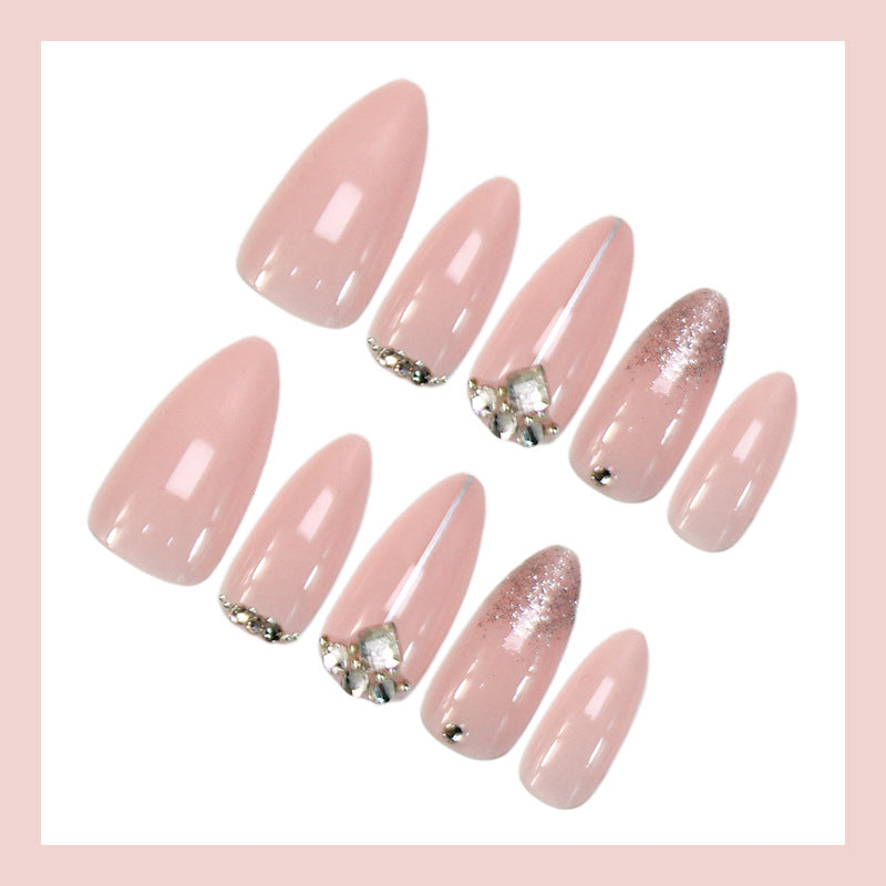 Glamorous artificial nails with rhinestone accents and shimmering effects Stornfield