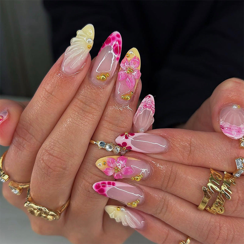 Artificial nails with floral accents and glitter decorations Stornfield