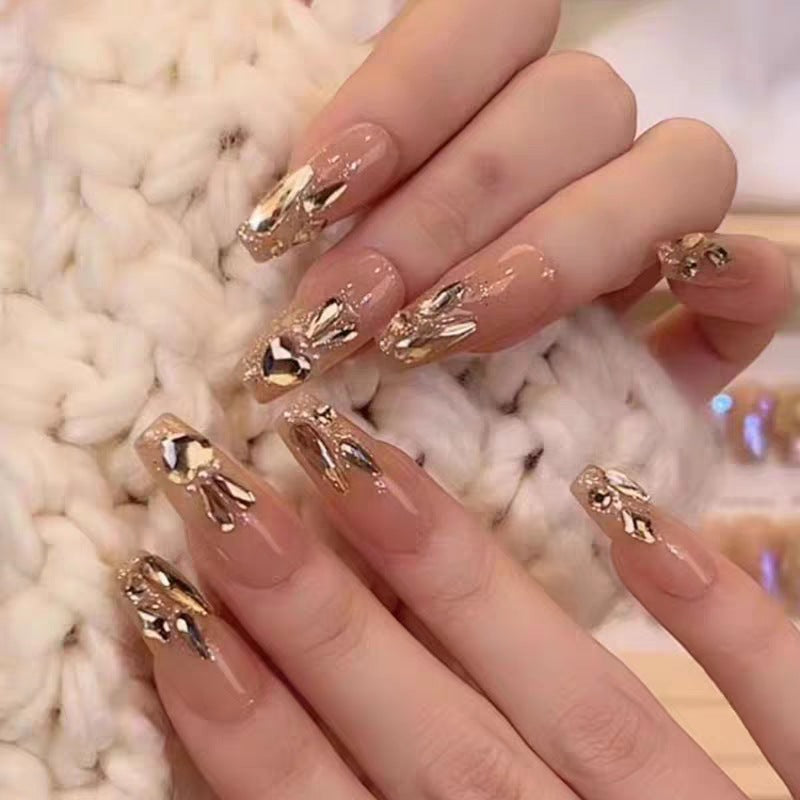 Glamorous artificial nails with gold decoration