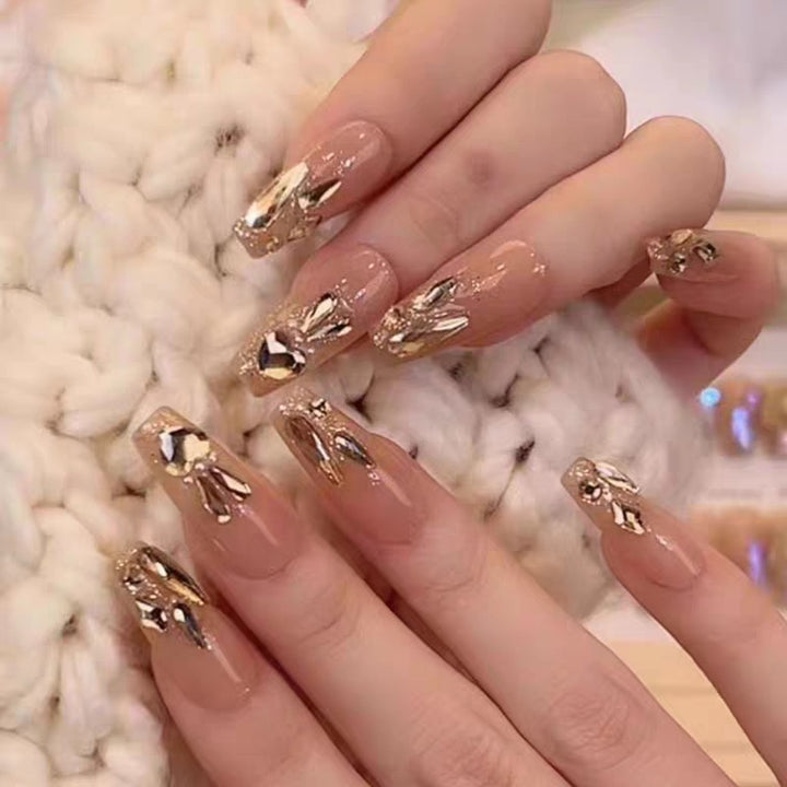 Glamorous artificial nails with gold decoration