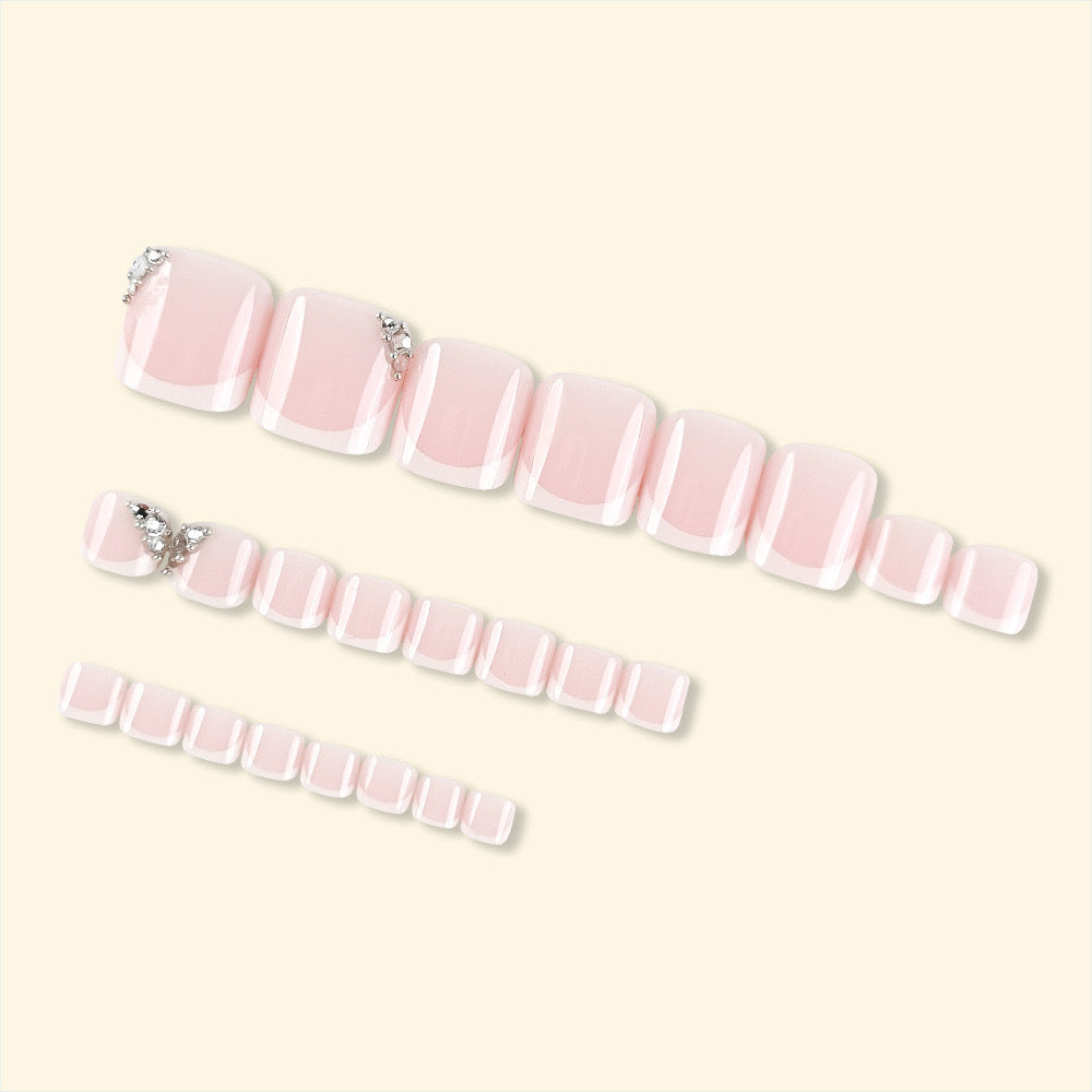 Artificial nail set with elegant French manicure and glitter accents Stornfield