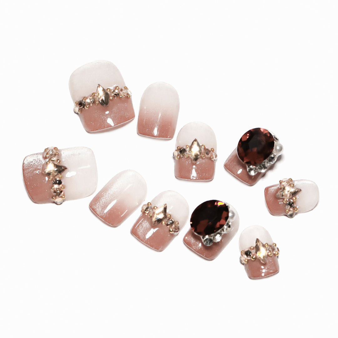 Artificial nail art with glitter and jewelry embellishments Stornfield