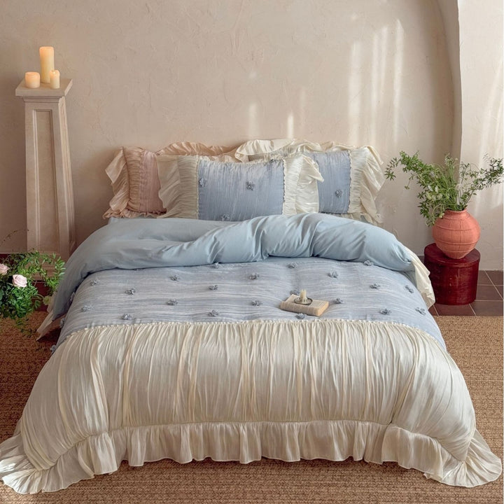 Satin look quilted bedspread with pleated ruffle and 3D flower appliqué