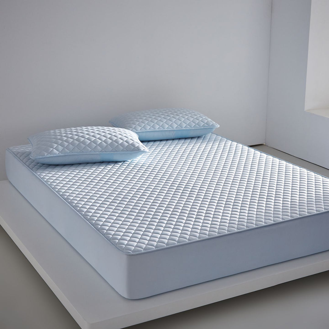 Breathable cooling mattress topper with quilted surface and elastic corner bands