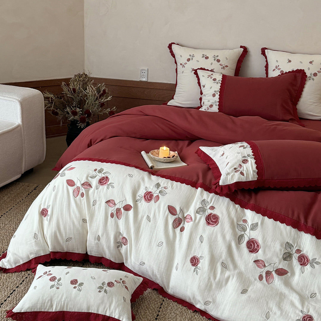 Bedding set with embroidered rose motif, ruffle and reversible feature