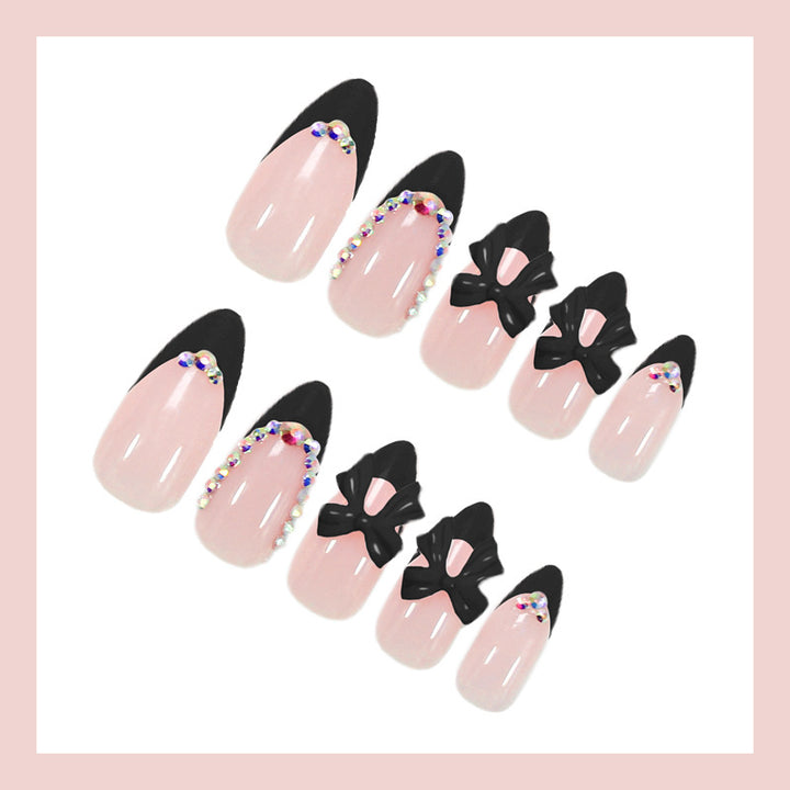 Artificial nail set with glamorous bow design and sparkling accents Stornfield
