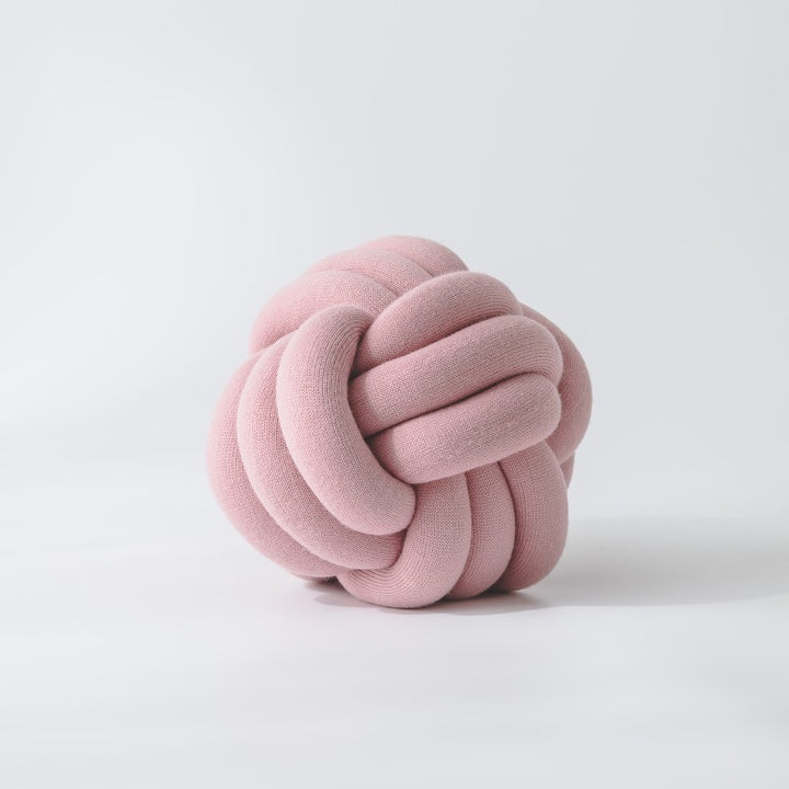 Decorative knitted knot cushion as a decorative pillow made of soft jersey