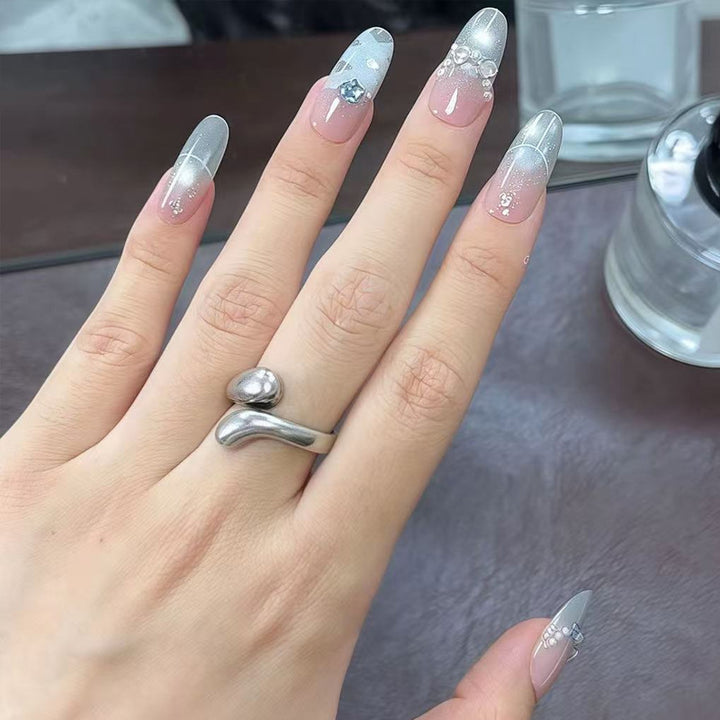 Artificial nail set with glamorous 3D details and radiant accents Stornfield