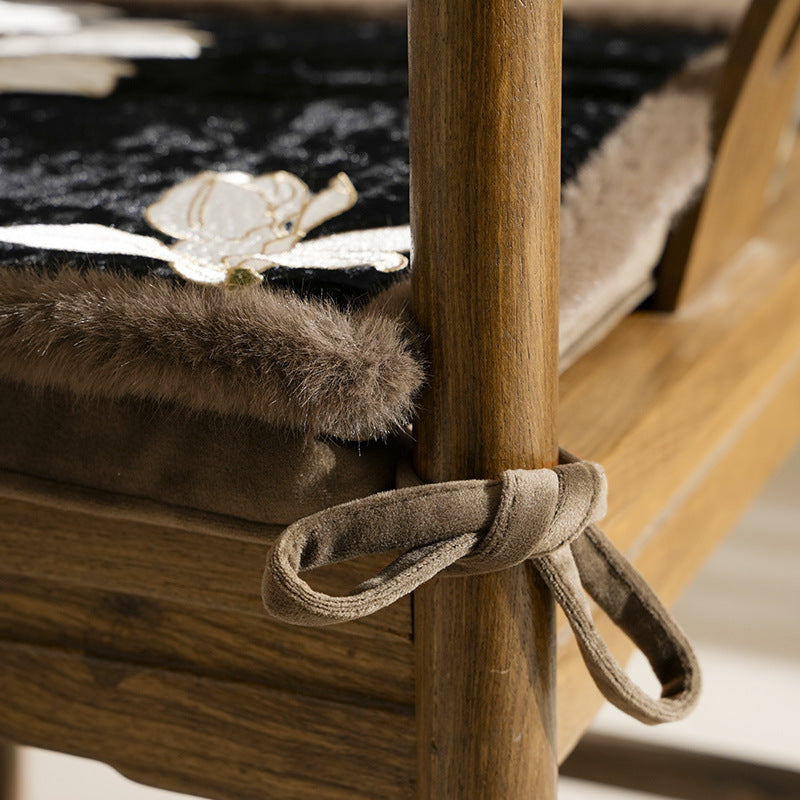 Padded seat cushion with velvet cover, floral embroidery and faux fur border