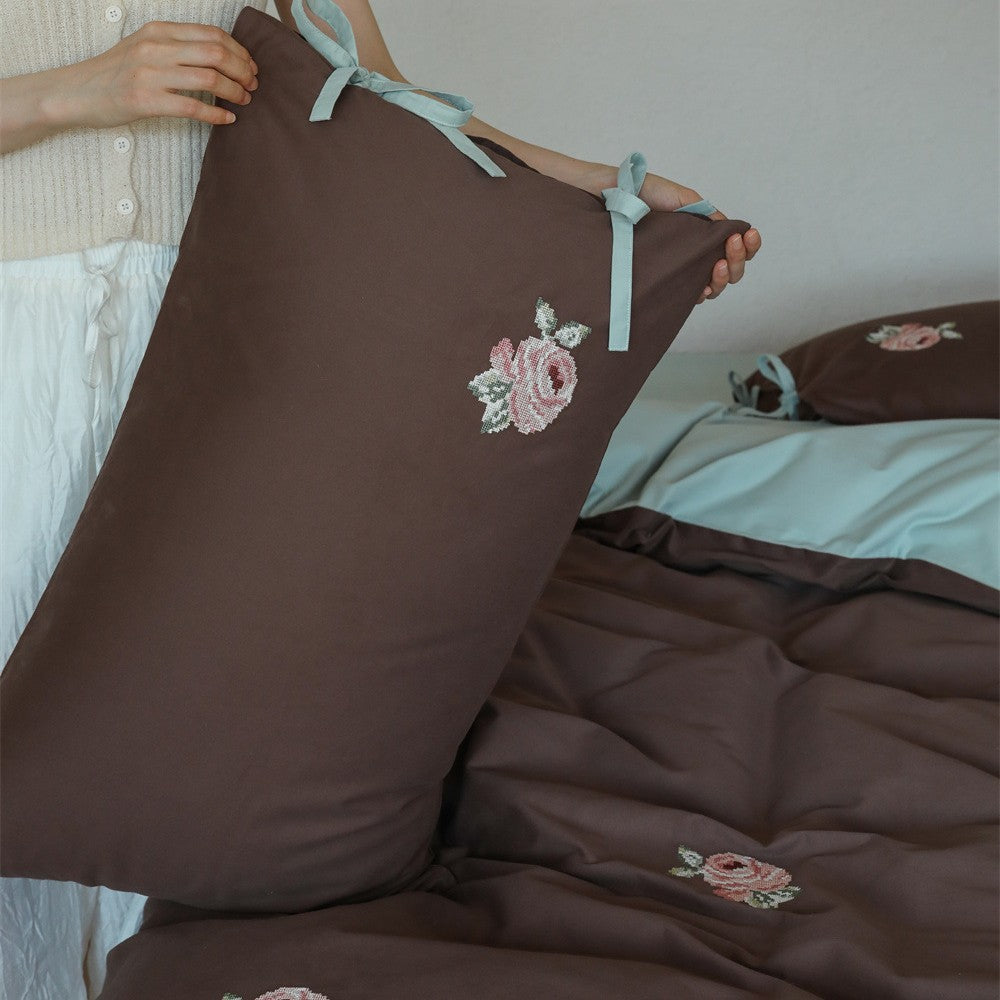 Reversible cotton bedding set with rose embroidery and decorative roll