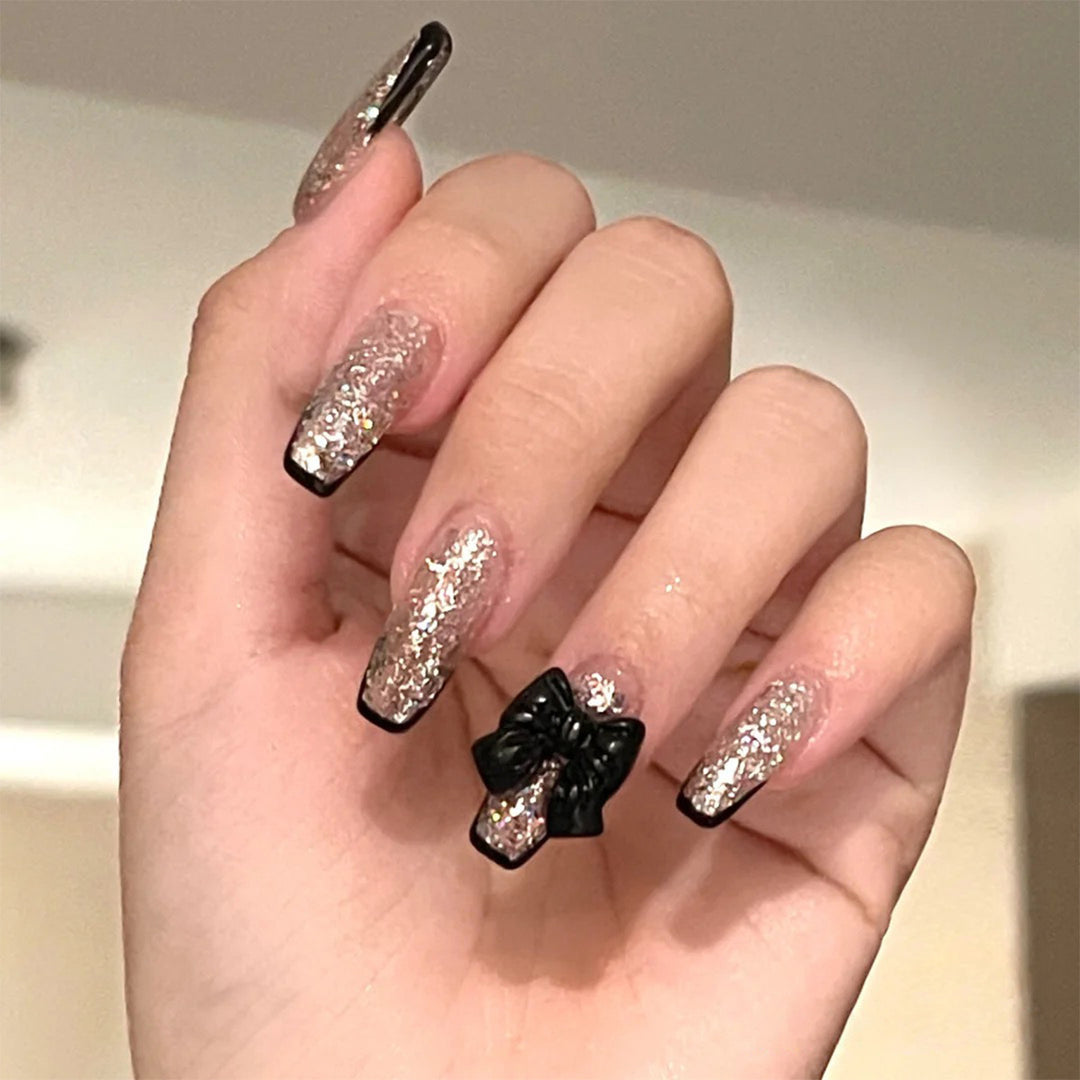Artistic Nail Extensions with Glitter and Bow Accents Stornfield