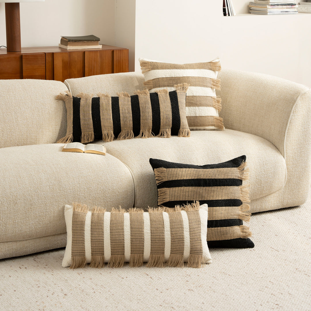 Woven cushion cover with bouclé surface and jute fringes Stornfield